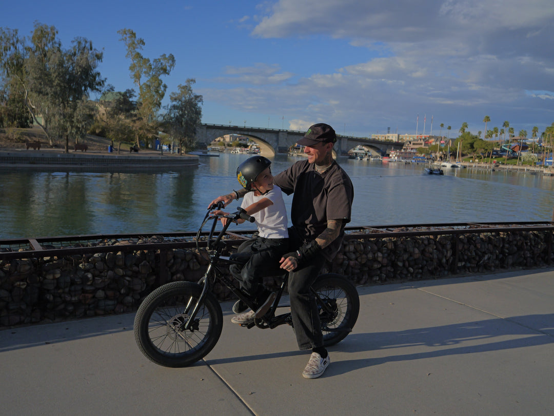 “Parent commuting on an electric bike with a young child in a secure bike seat, showing family-friendly eBike transportation.”